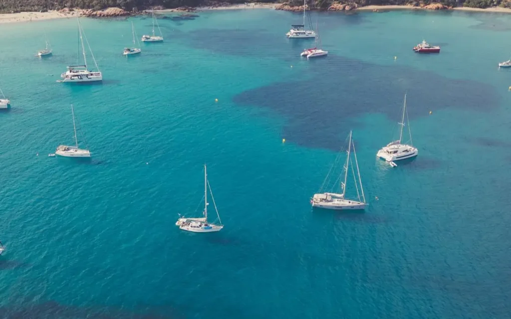 Aerial photo capturing yachts anchored in a tranquil bay in