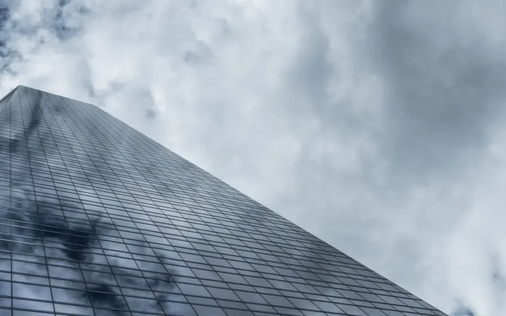 Low angle view of a towering modern skyscraper with glass wi